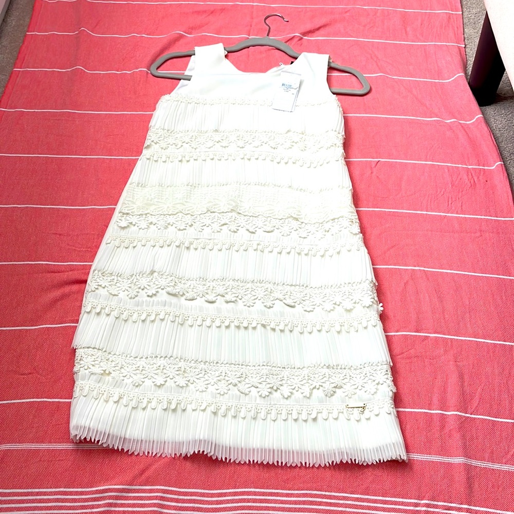 Beautiful guess white floral dress with trimming never been worn new with tags